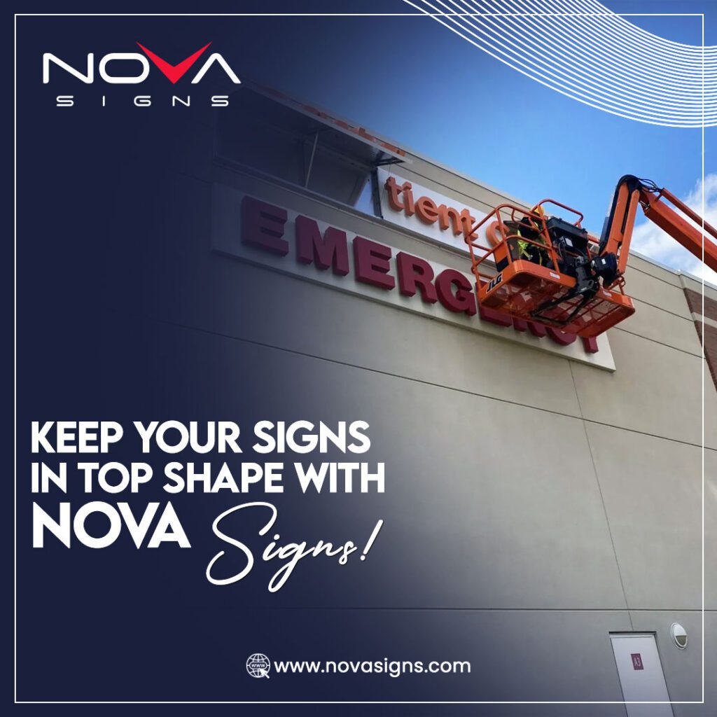 Two workers on a cherry picker adjusting letters on a building's emergency sign, showcasing sign maintenance services by Nova Signs.